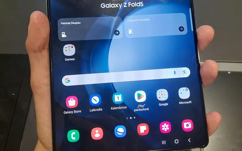 Hand holding an unfolded Samsung Galaxy Z Fold showing the inner display