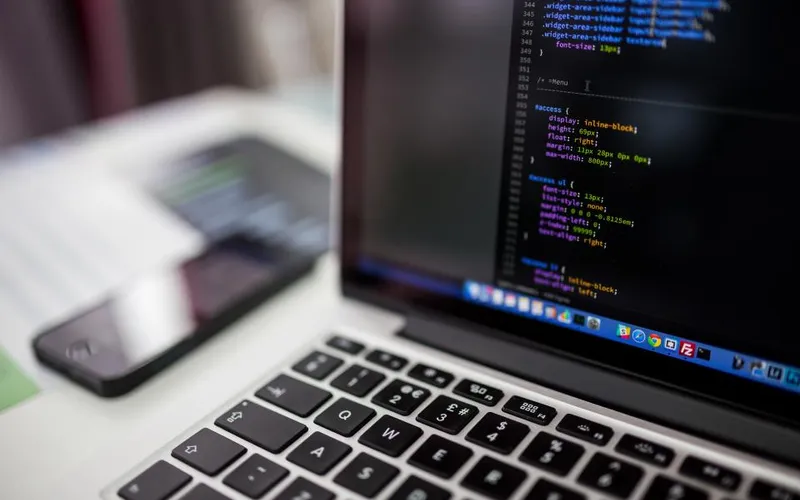 Laptop screen showing source code in a development environment